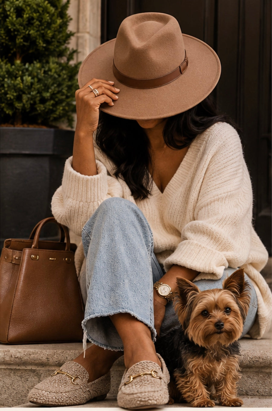 Dog mom sitting on porch stoop with her Yorkie.